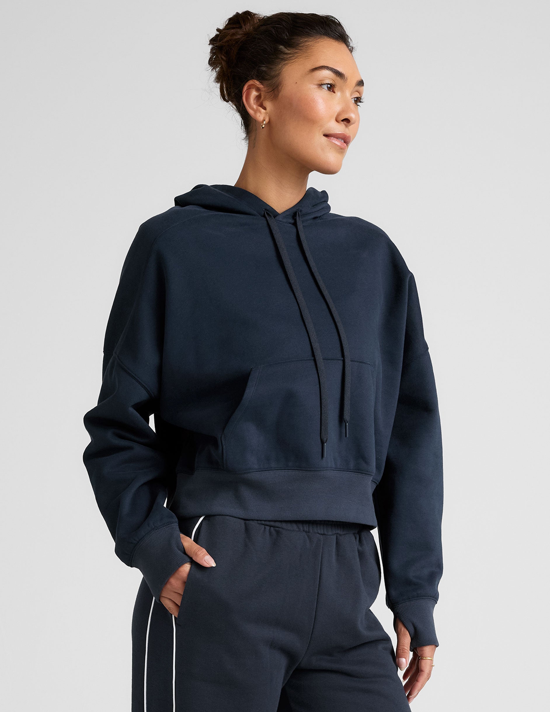blue cropped pullover with a hood with drawcord and a kangaroo pocket.