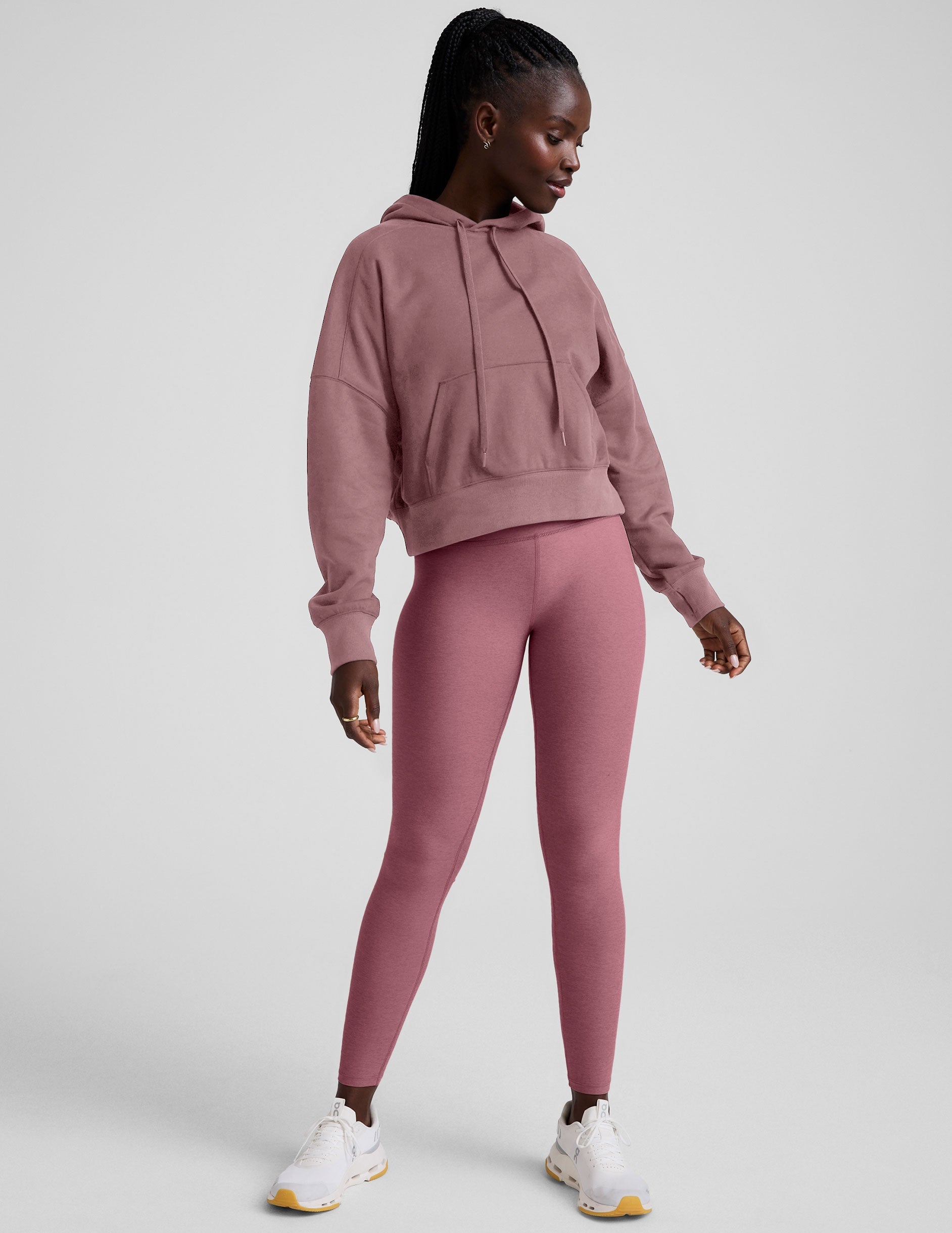 pink cropped pullover with a hood with drawcord and a kangaroo pocket.