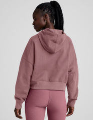 pink cropped pullover with a hood with drawcord and a kangaroo pocket.