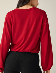 red v-neck cropped sweater.