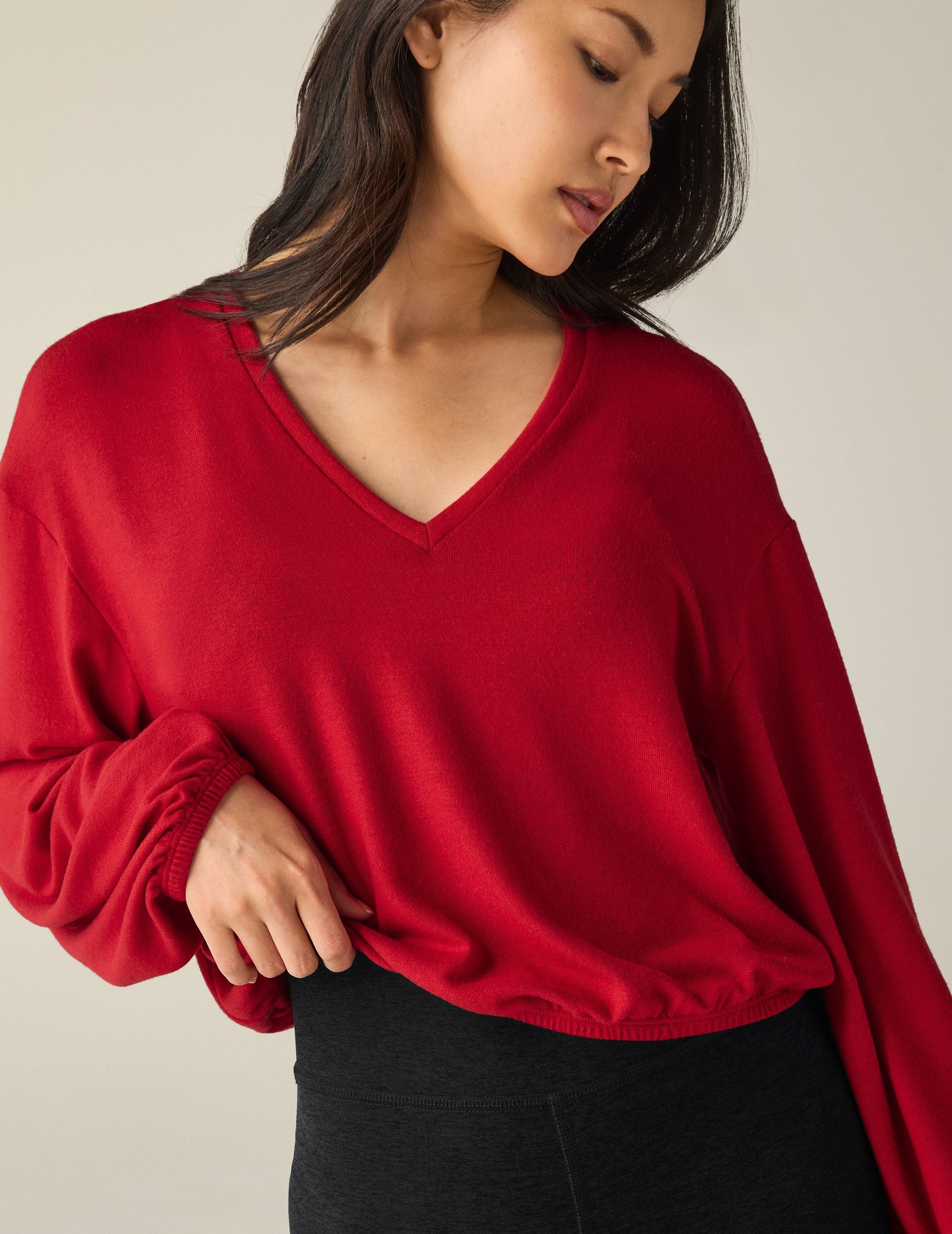 red v-neck cropped sweater.