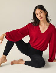 red v-neck cropped sweater.