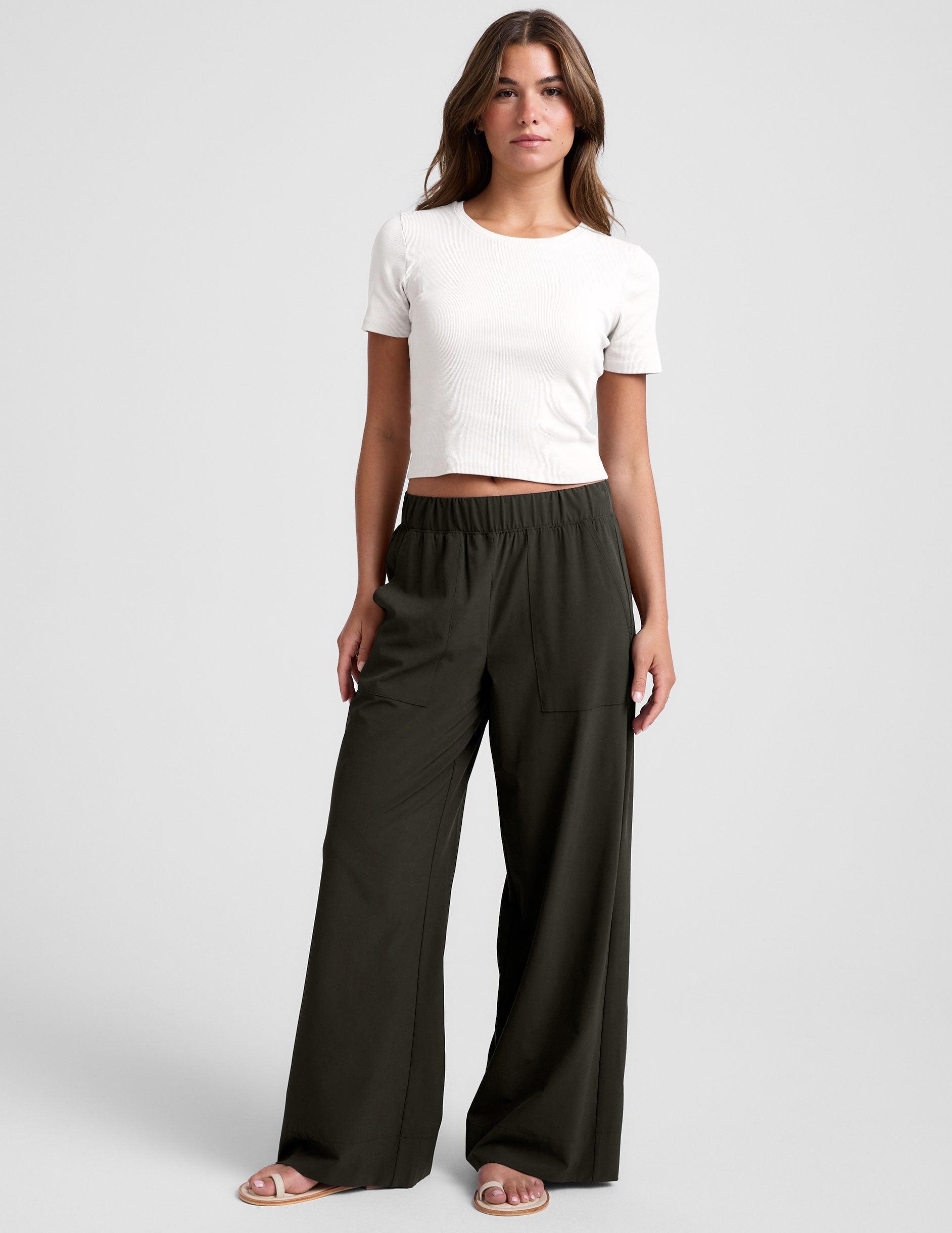 green mid rise pants with front and side pockets.