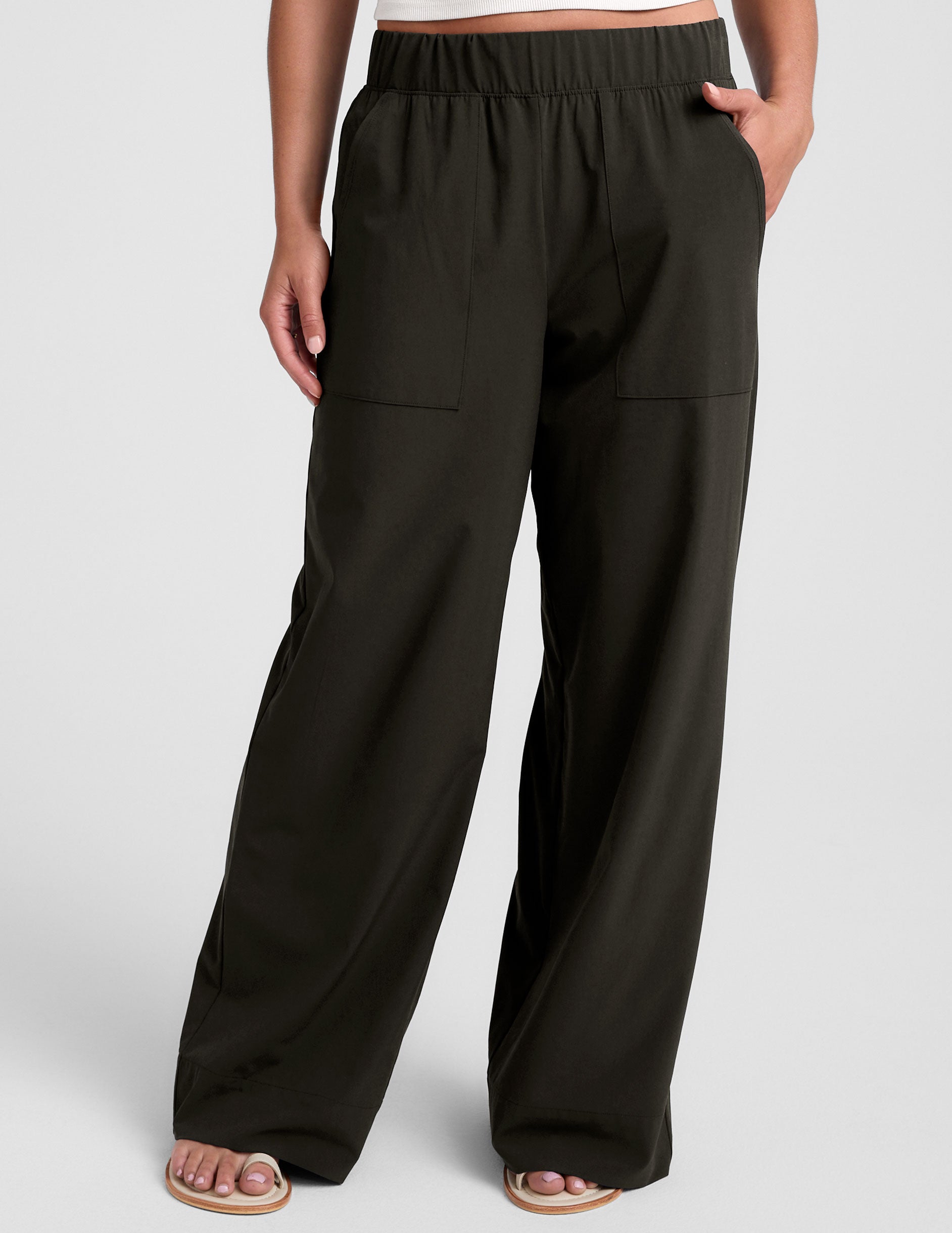 green mid rise pants with front and side pockets.
