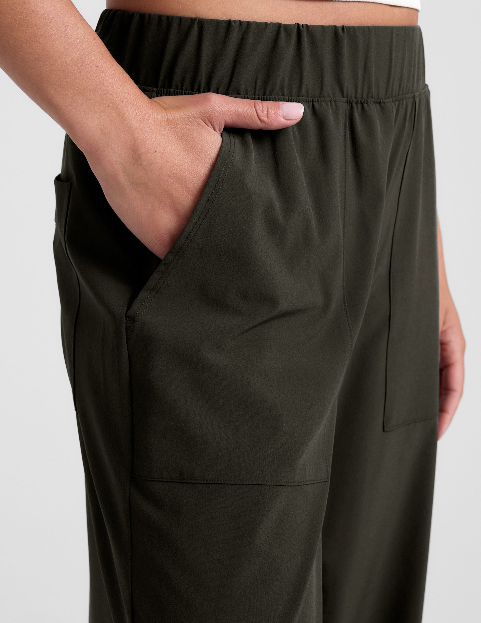 green mid rise pants with front and side pockets.