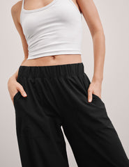 black mid rise relaxed fit wide leg pant with front side seam pockets and back pockets.