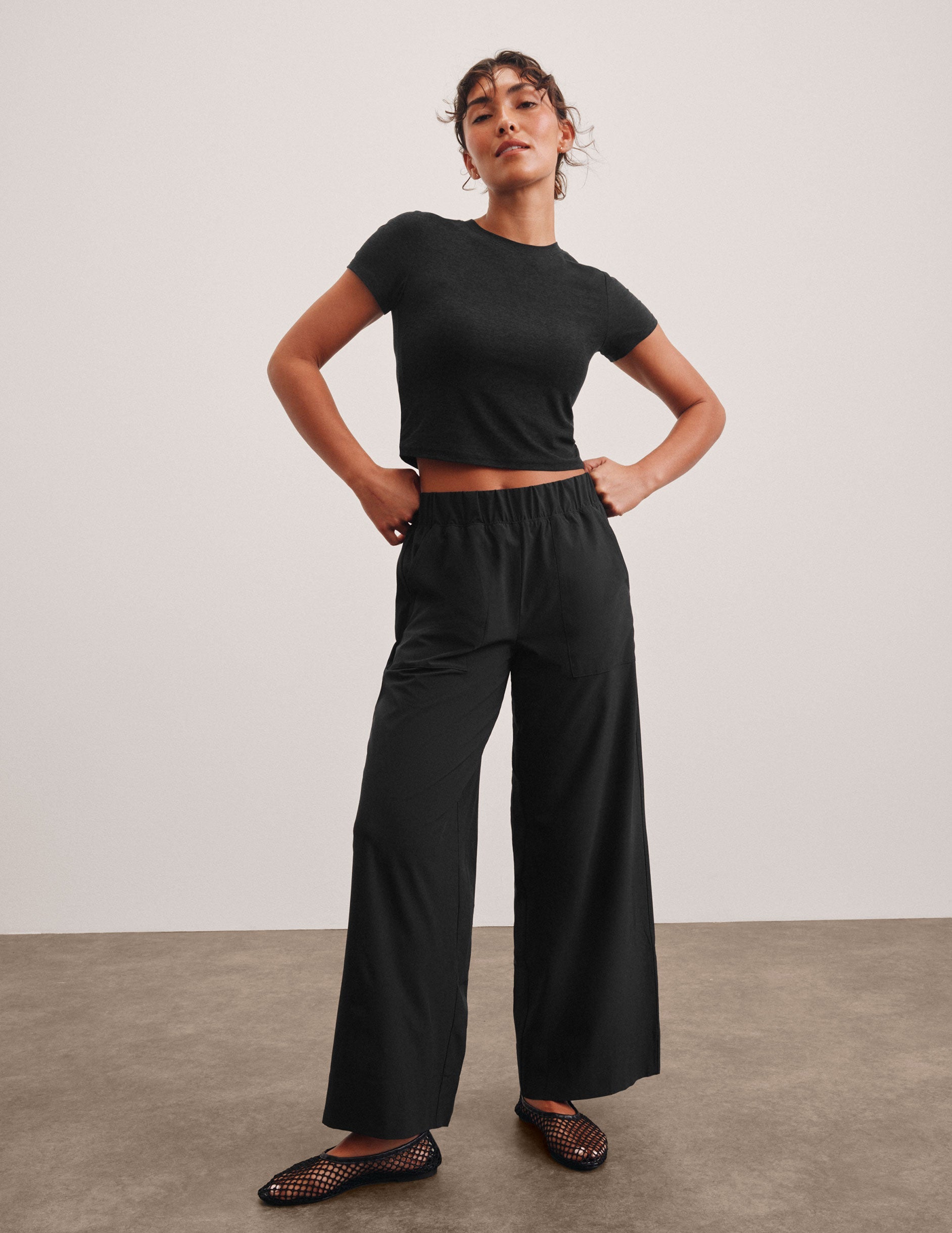 black mid rise relaxed fit wide leg pant with front side seam pockets and back pockets.