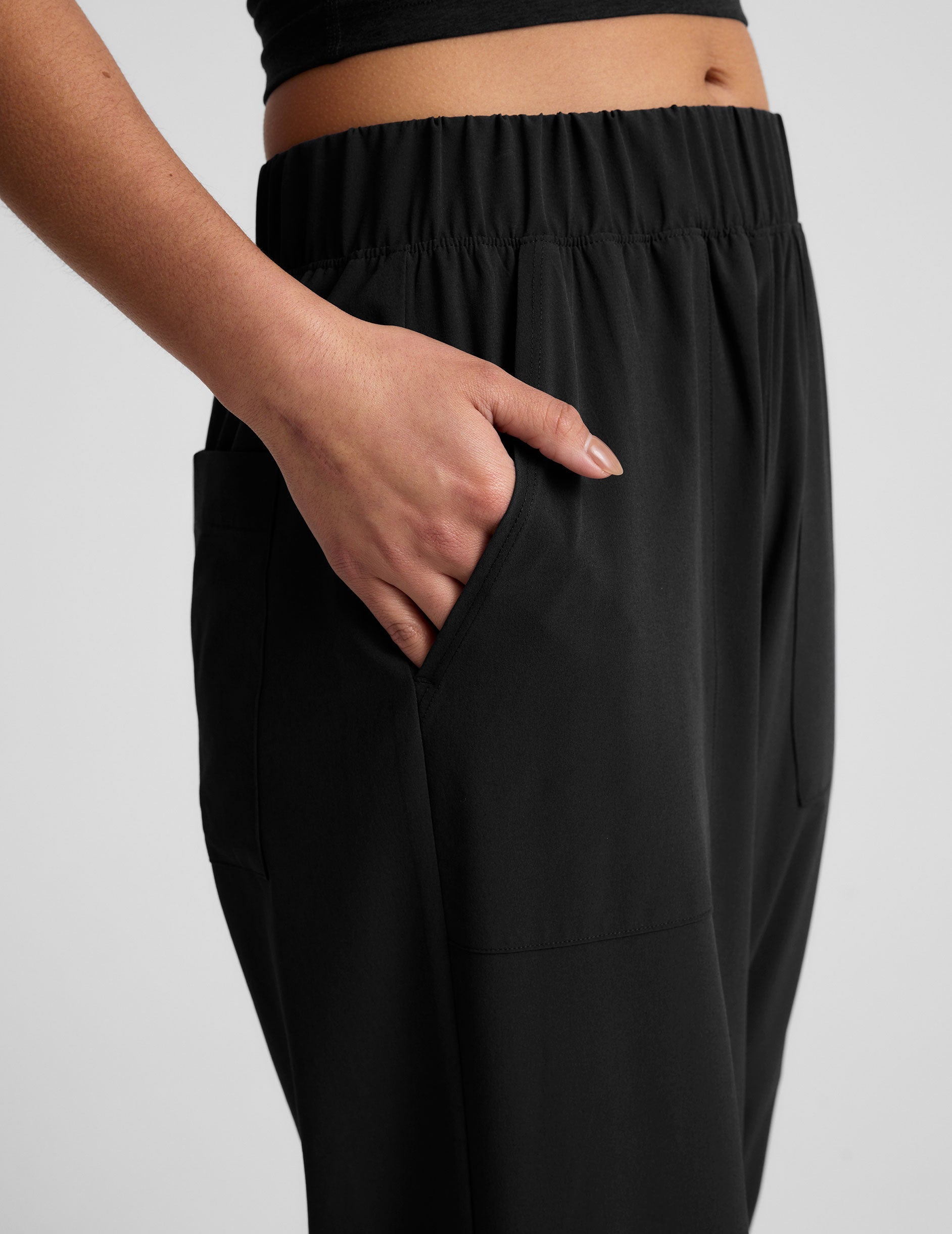 black mid rise relaxed fit wide leg pant with front side seam pockets and back pockets.
