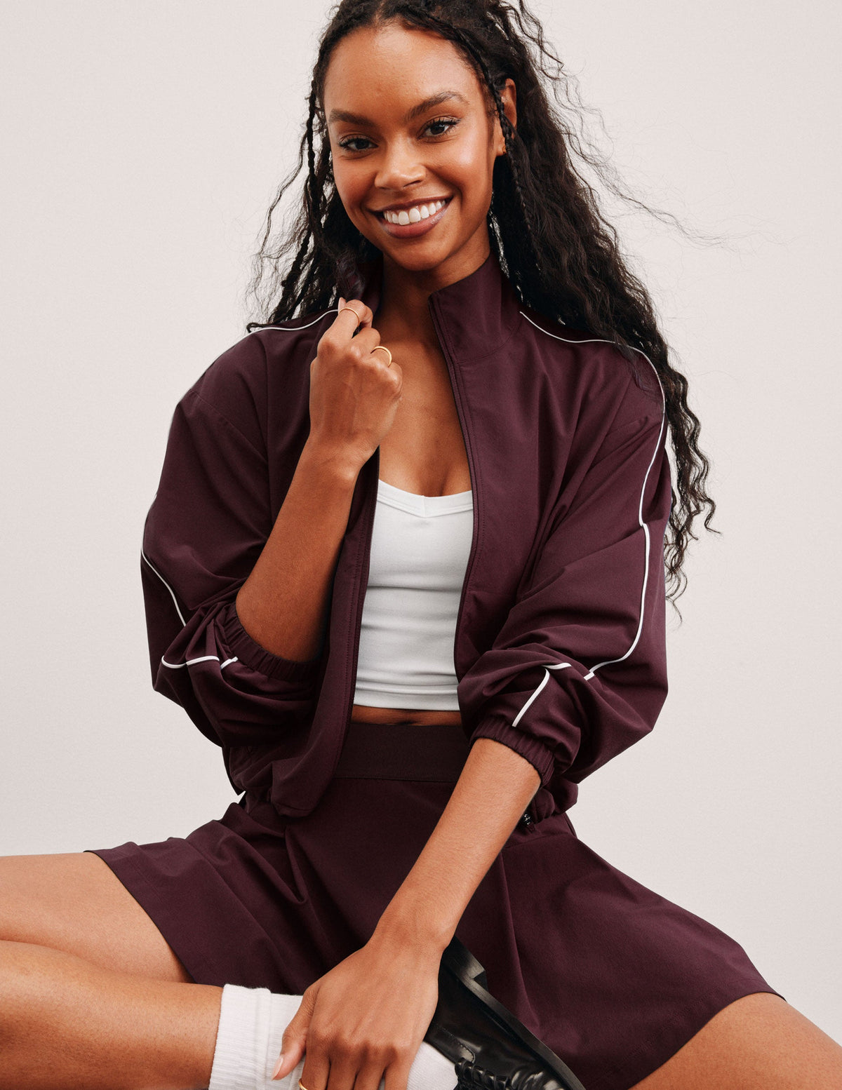 red zip-up jacket with white piping and pockets.