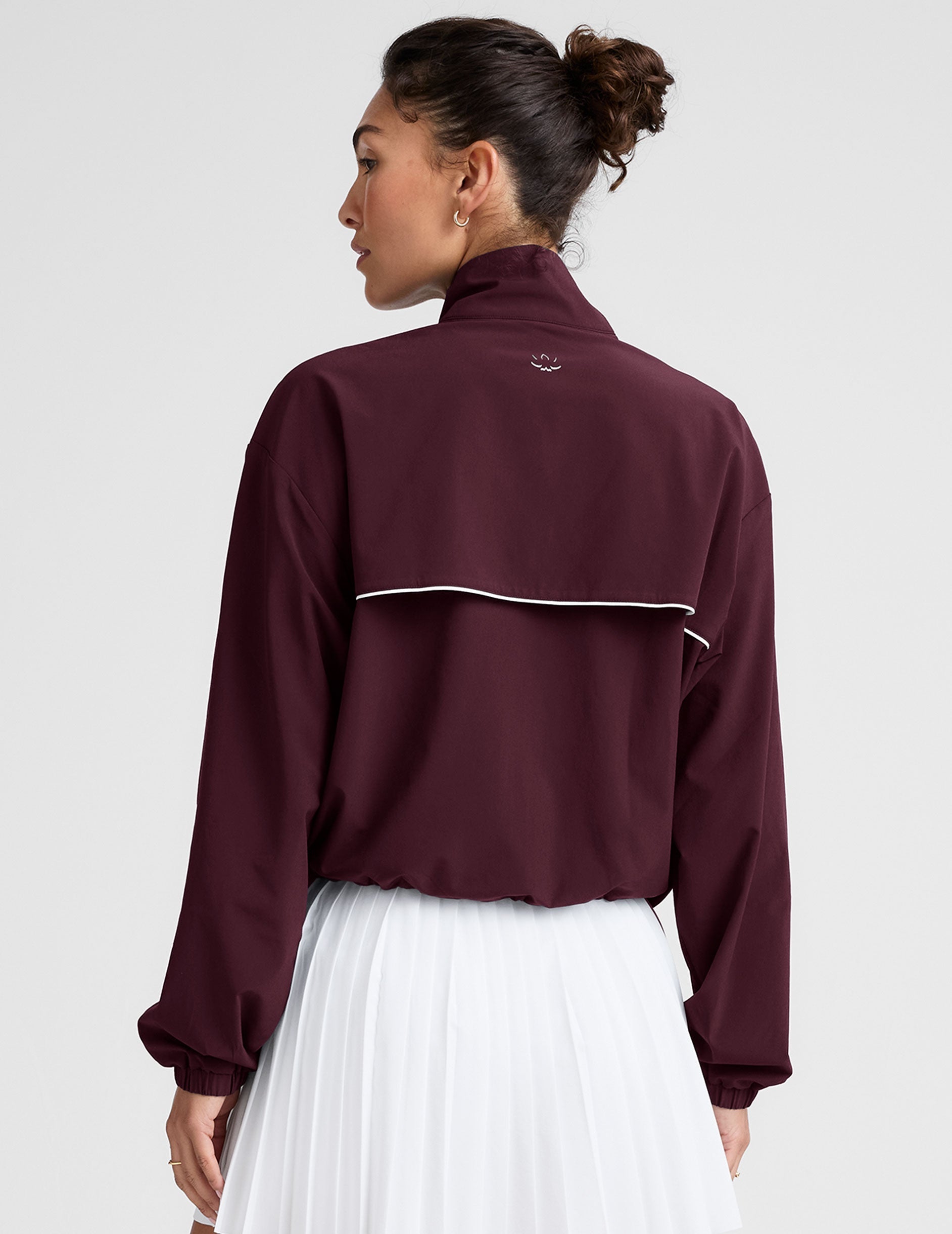 red zip-up jacket with white piping and pockets.