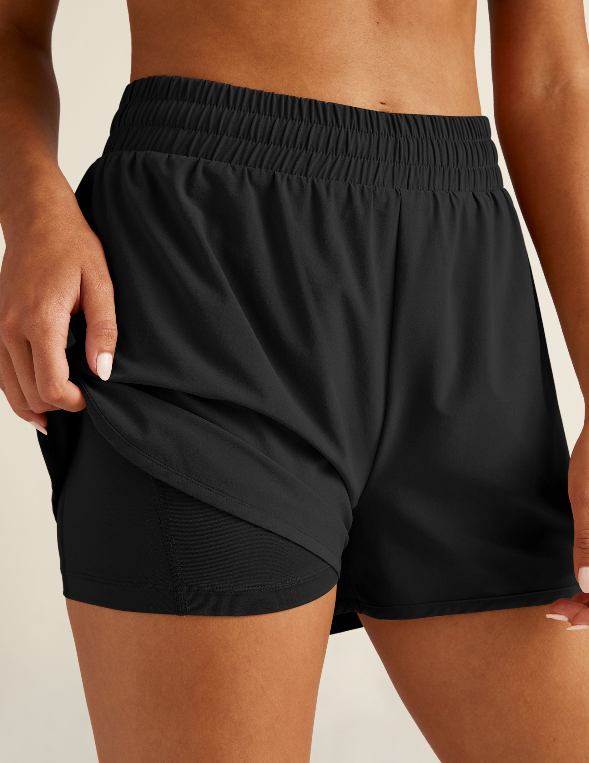 black athletic shorts with built-in shorts underneath.