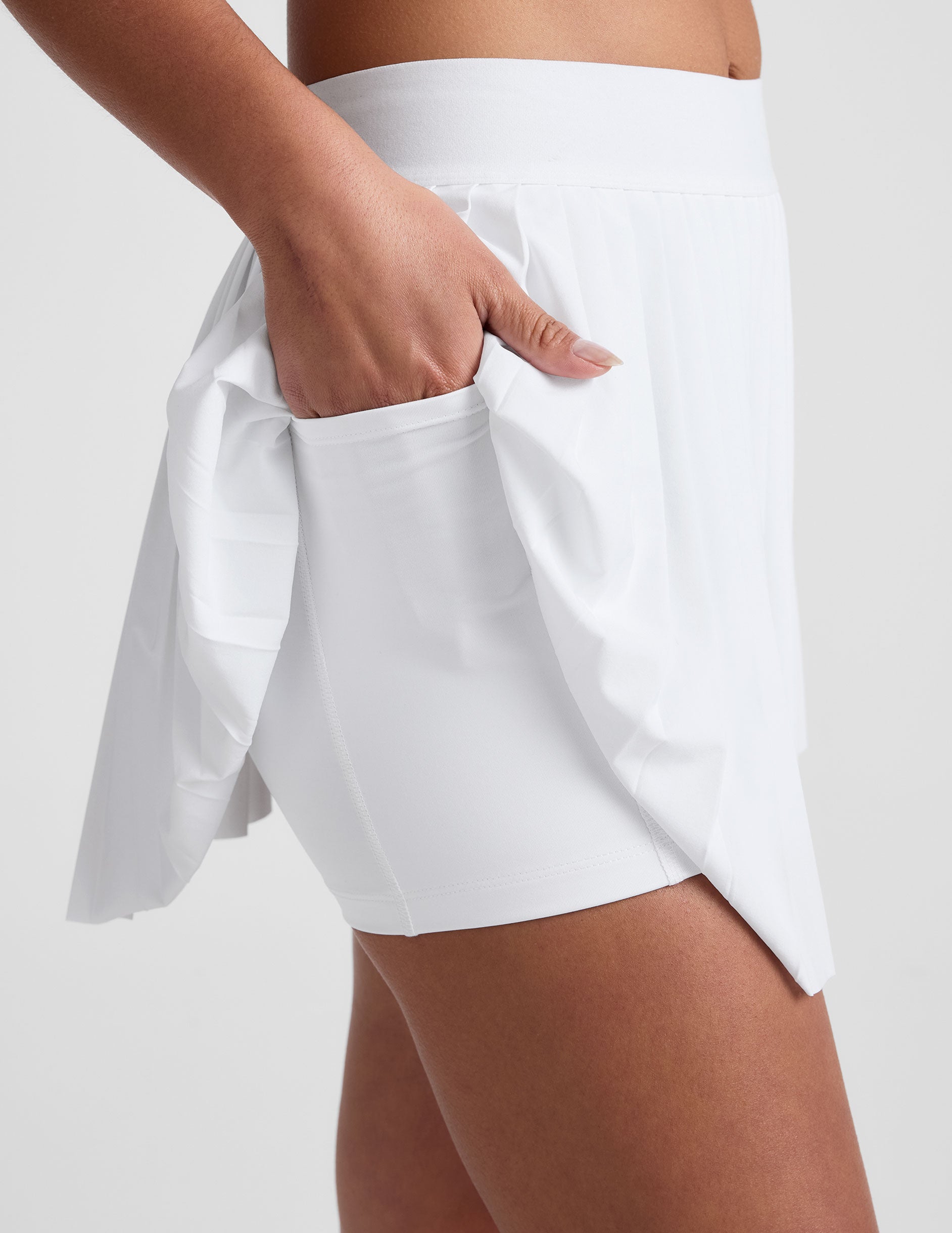 white pleated mini skirt with shorts underneath.