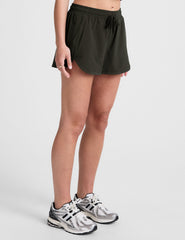 green 2.5" inseam shorts with side pockets and a drawstring at waistband. 