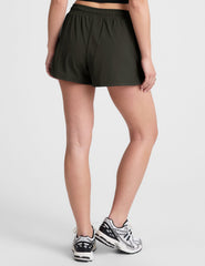 green 2.5" inseam shorts with side pockets and a drawstring at waistband. 