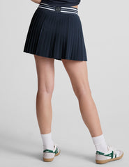 blue mini length pleated skirt with an exposed stripped elastic waistband​ and 
internal performance shorts with pockets​. 