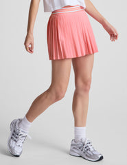 pink pleated mini skirt with an exposed stripped elastic waistband​ and internal performance shorts with pockets​.