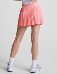 pink pleated mini skirt with an exposed stripped elastic waistband​ and internal performance shorts with pockets​.