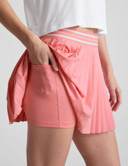 pink pleated mini skirt with an exposed stripped elastic waistband​ and internal performance shorts with pockets​.