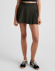 green mini pleated skirt with built-in shorts with pockets.