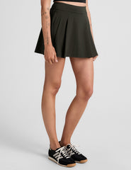 green mini pleated skirt with built-in shorts with pockets.