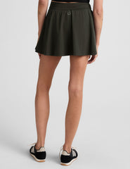 green mini pleated skirt with built-in shorts with pockets.