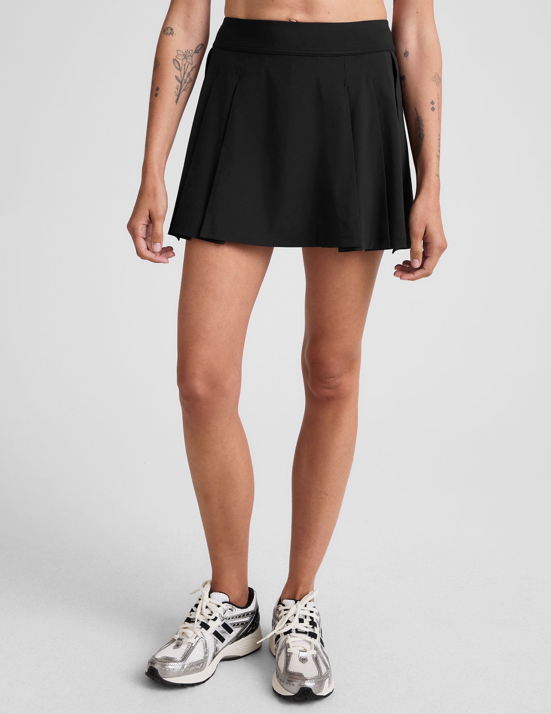 black mini pleated skirt with interior shorts with pockets.