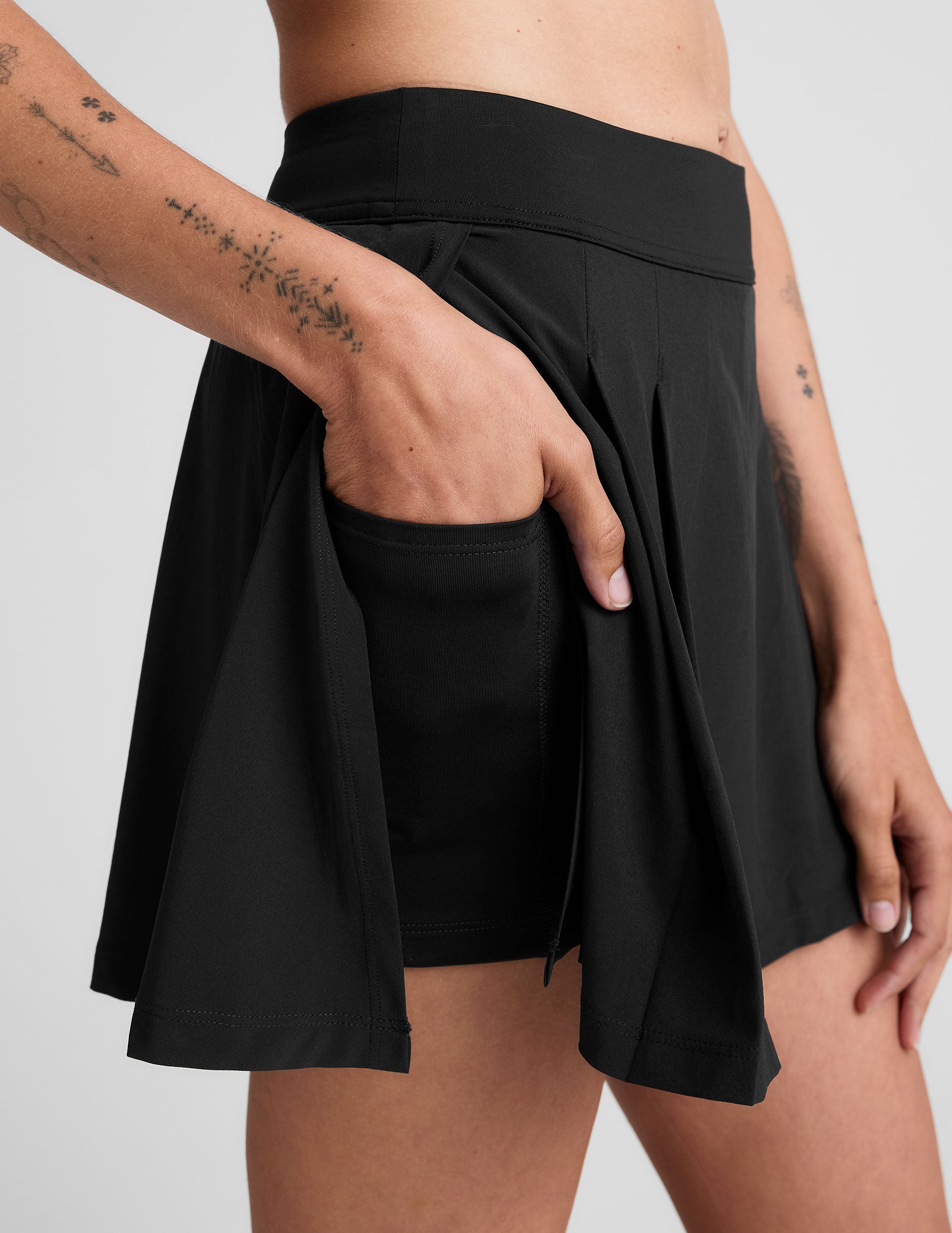 black mini pleated skirt with interior shorts with pockets.