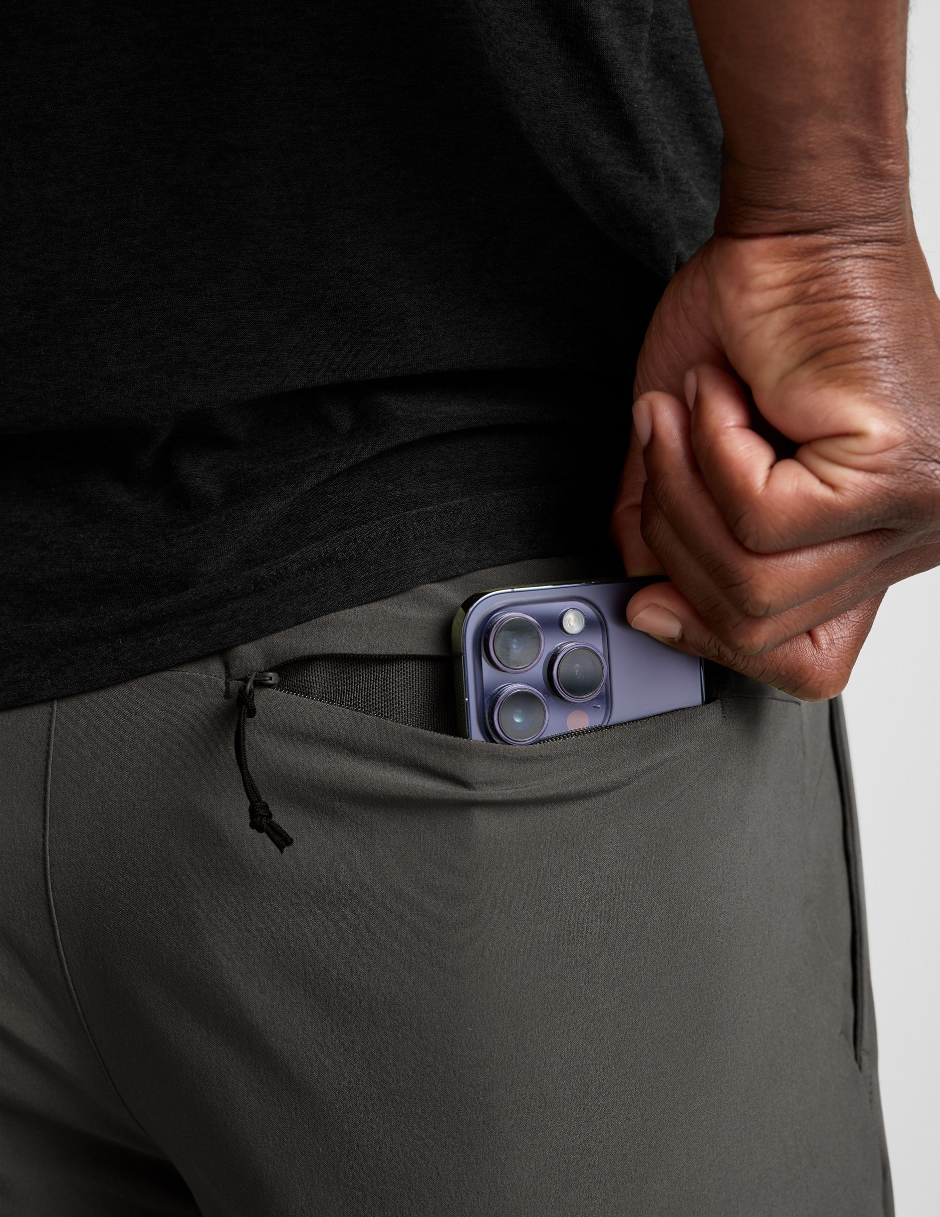 man wearing a long sleeve and graphite shorts on a white background.