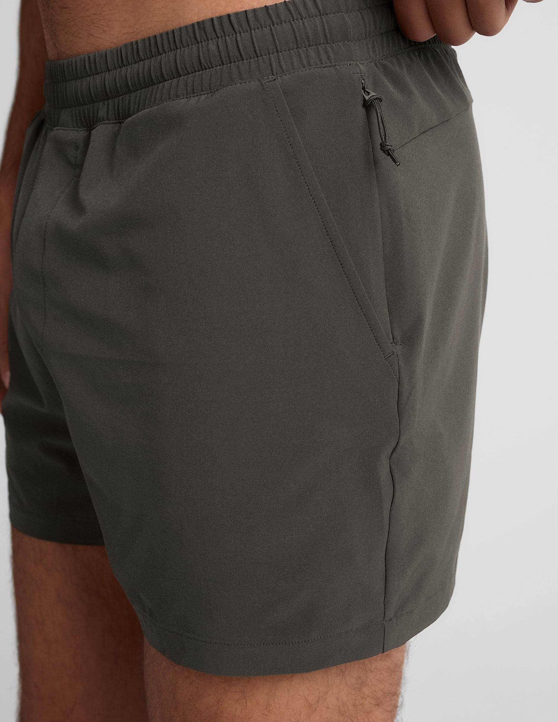 grey men's 5" shorts on a plain background. 