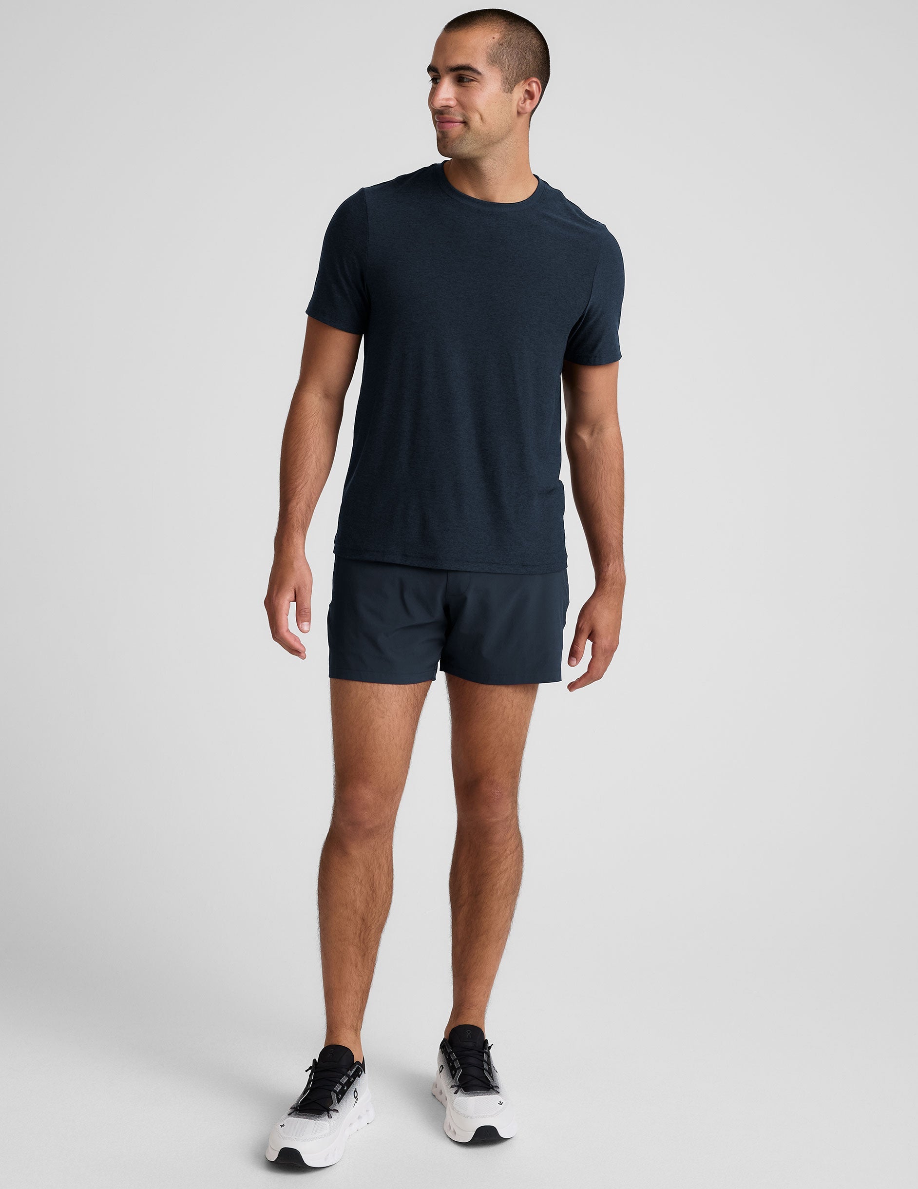 navy t-shirt and navy 5" shorts on a plain background. 