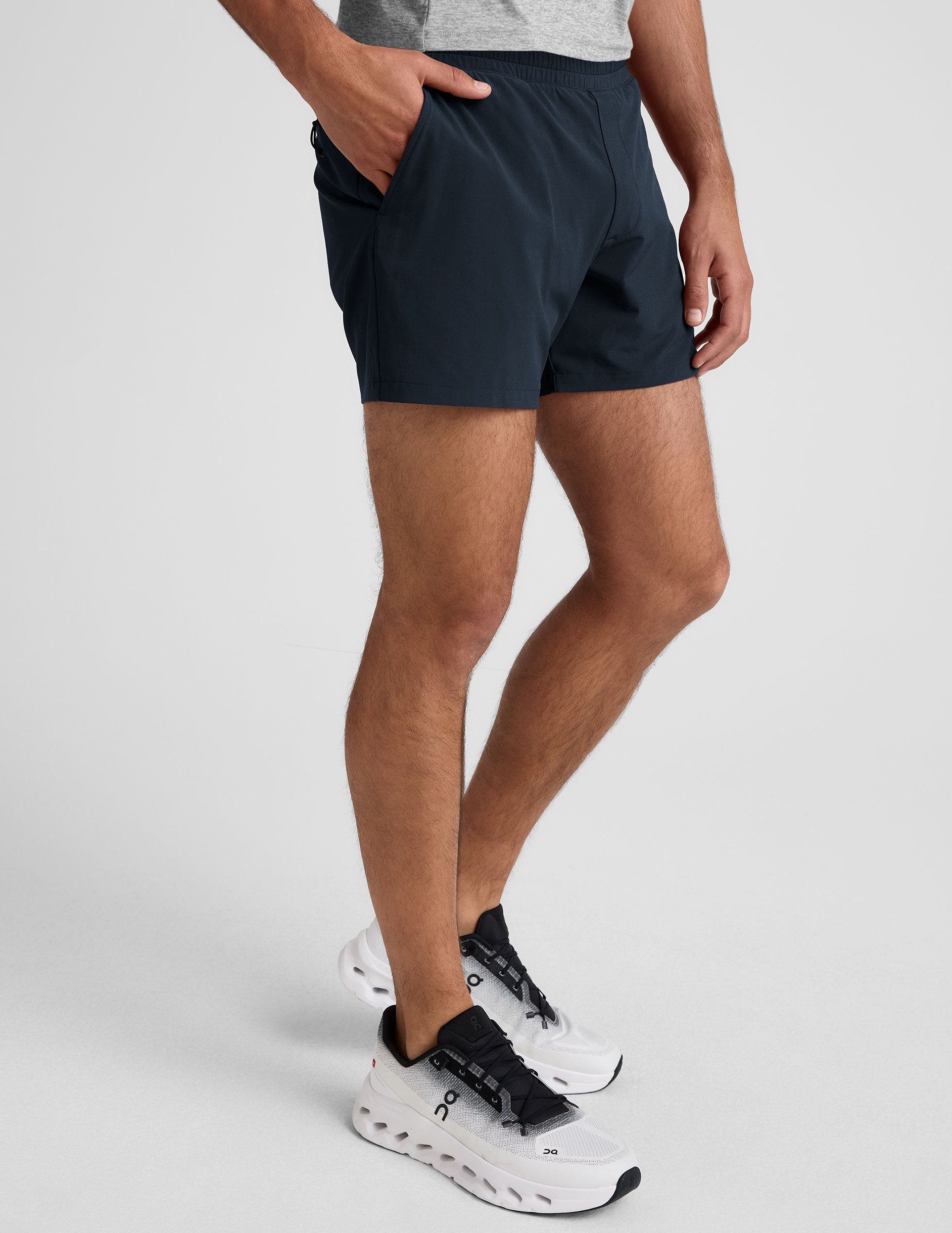 navy t-shirt and navy 5" shorts on a plain background. 