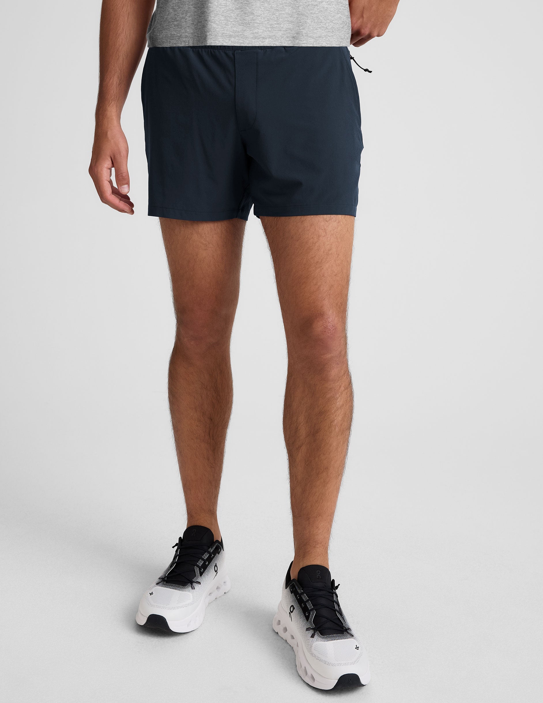 navy t-shirt and navy 5" shorts on a plain background. 