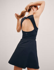 blue mini athletic dress with an open back detail and built-in shorts with pockets.