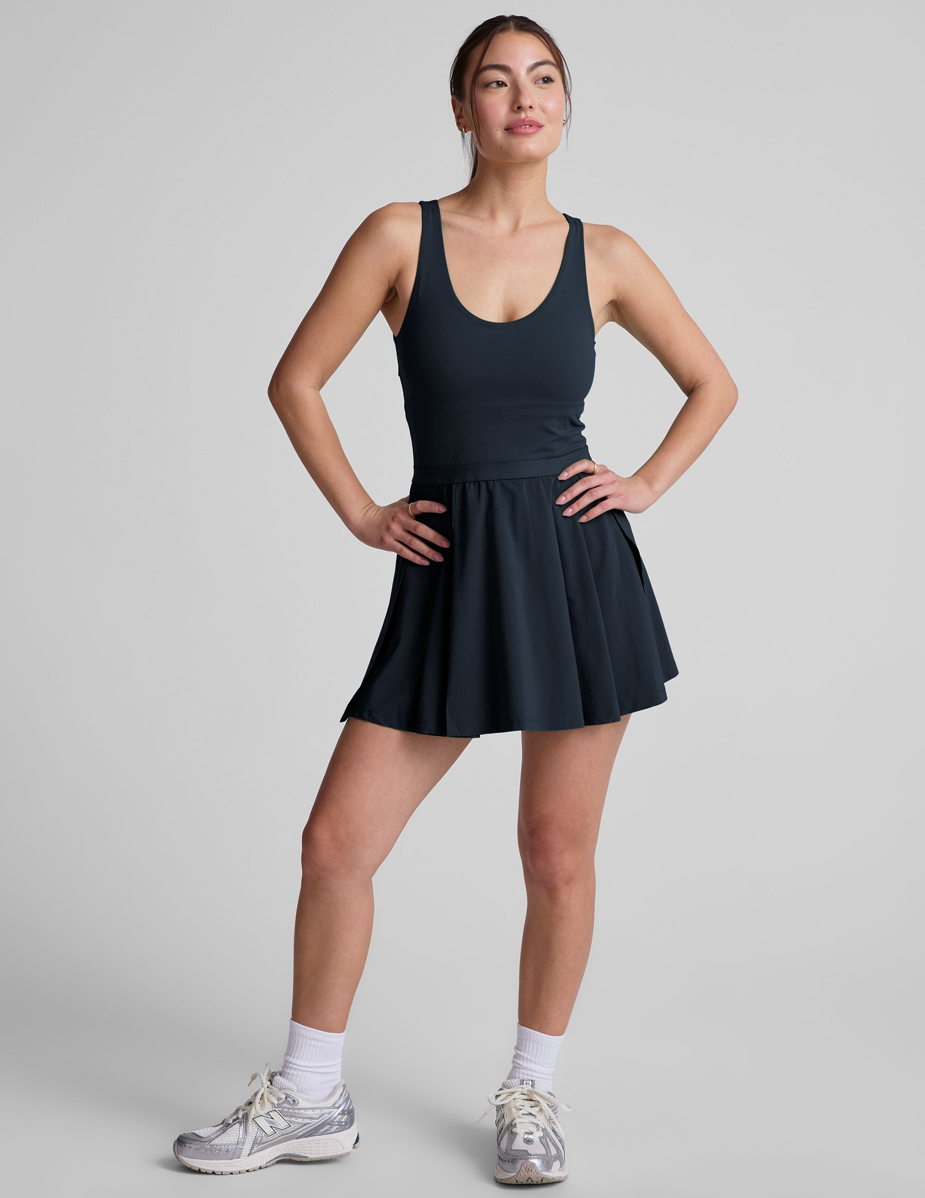 blue mini athletic dress with an open back detail and built-in shorts with pockets.