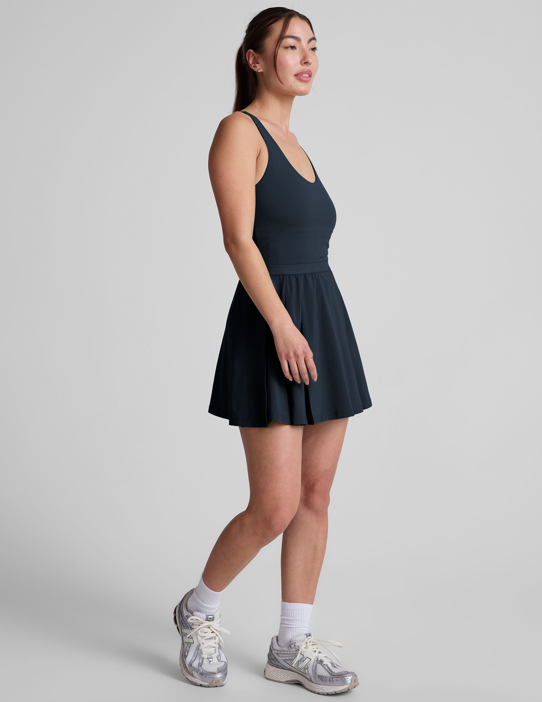 blue mini athletic dress with an open back detail and built-in shorts with pockets.