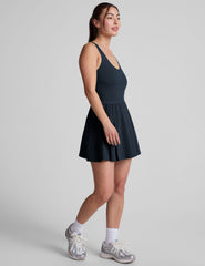 blue mini athletic dress with an open back detail and built-in shorts with pockets.