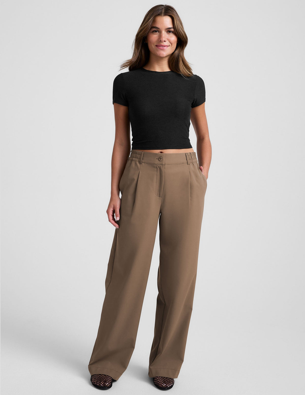 brown mid-rise trousers with pockets.