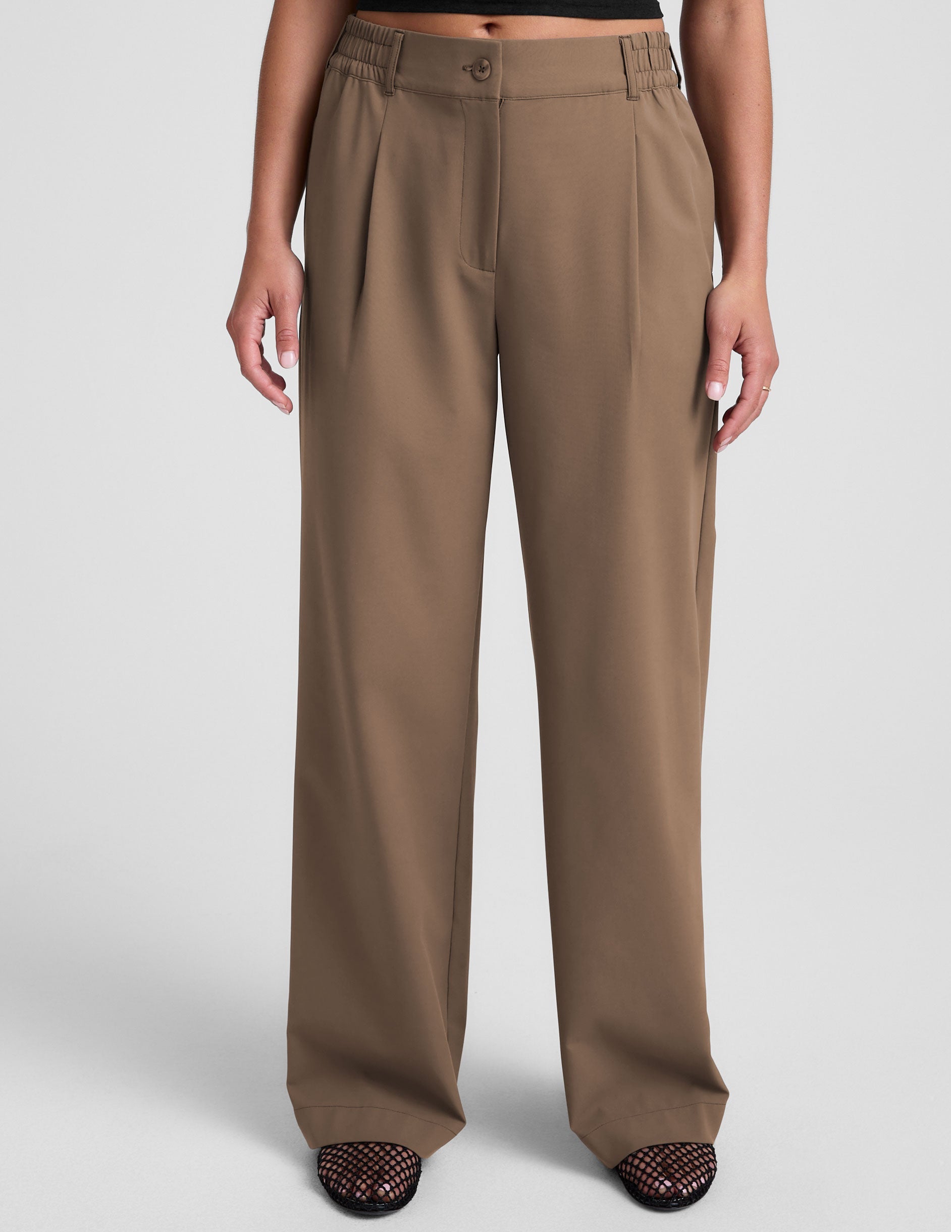 brown mid-rise trousers with pockets.