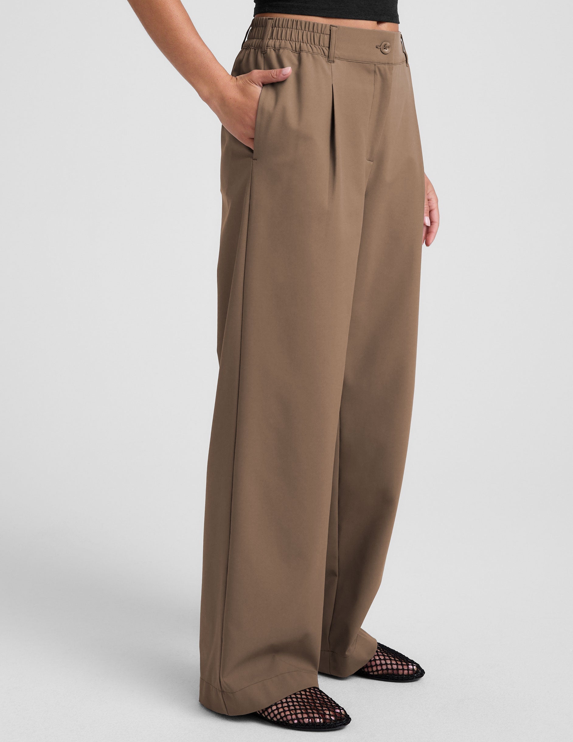brown mid-rise trousers with pockets.