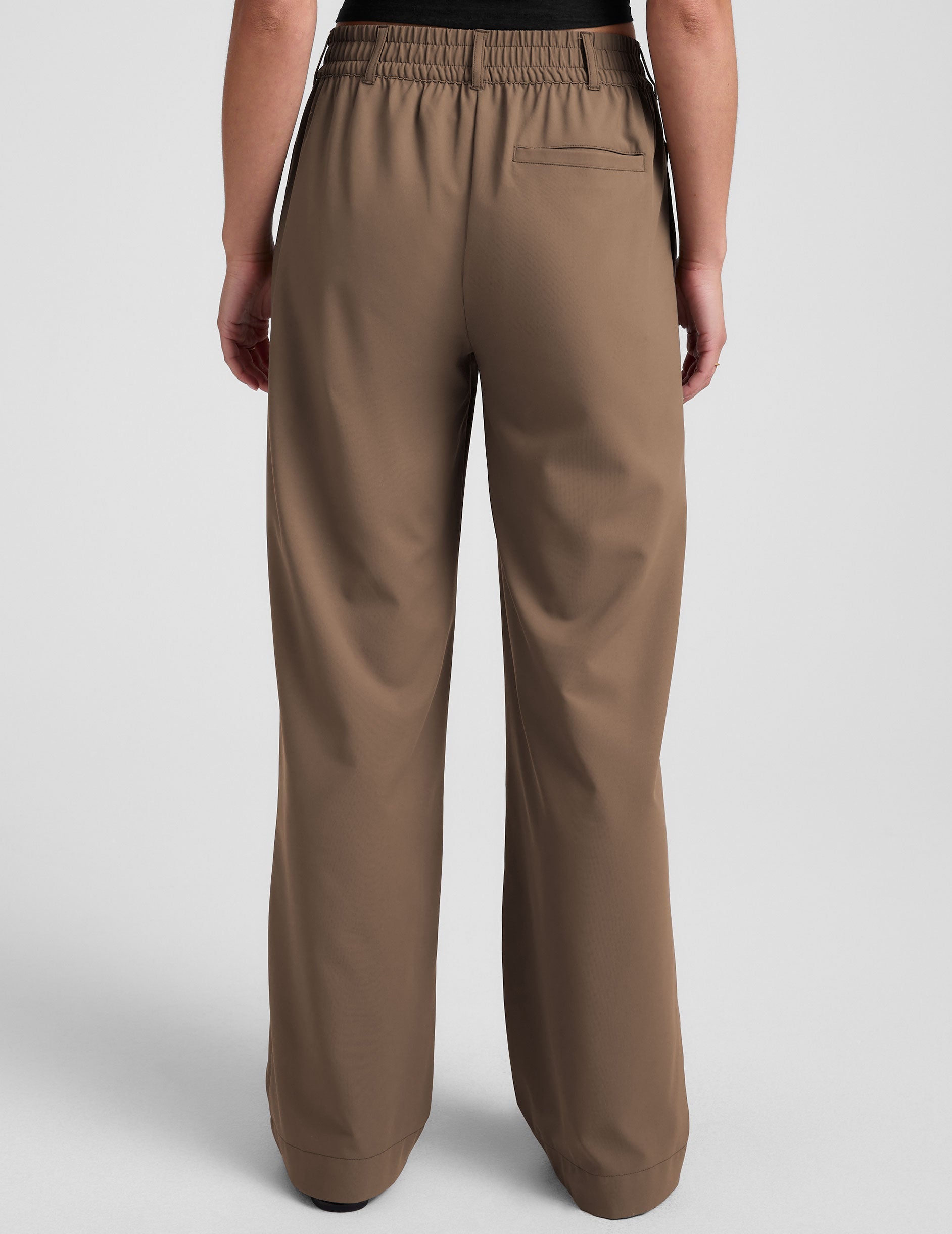 brown mid-rise trousers with pockets.
