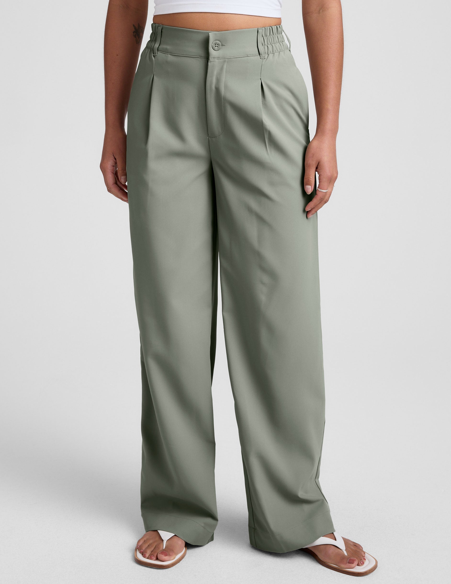 green mid-rise trouser pants with pockets.