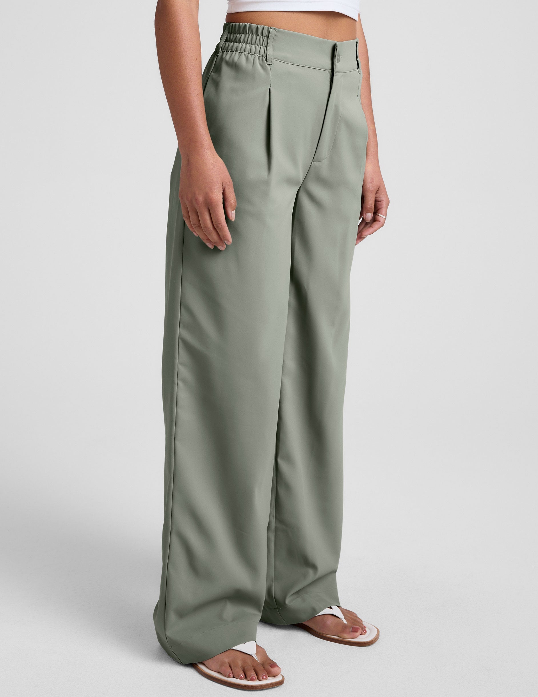 green mid-rise trouser pants with pockets.