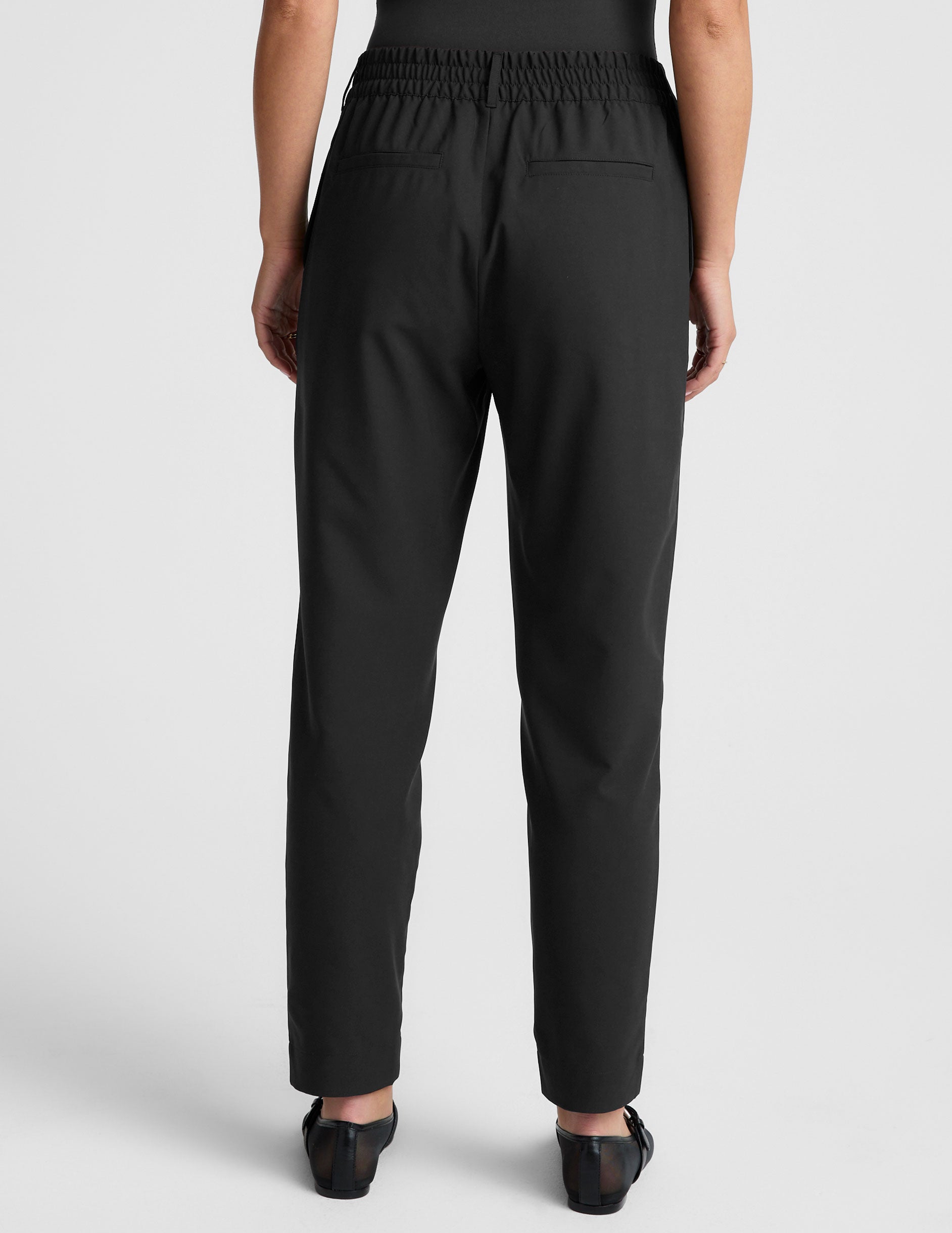 black trouser style pant with a tapered ankle and pockets.