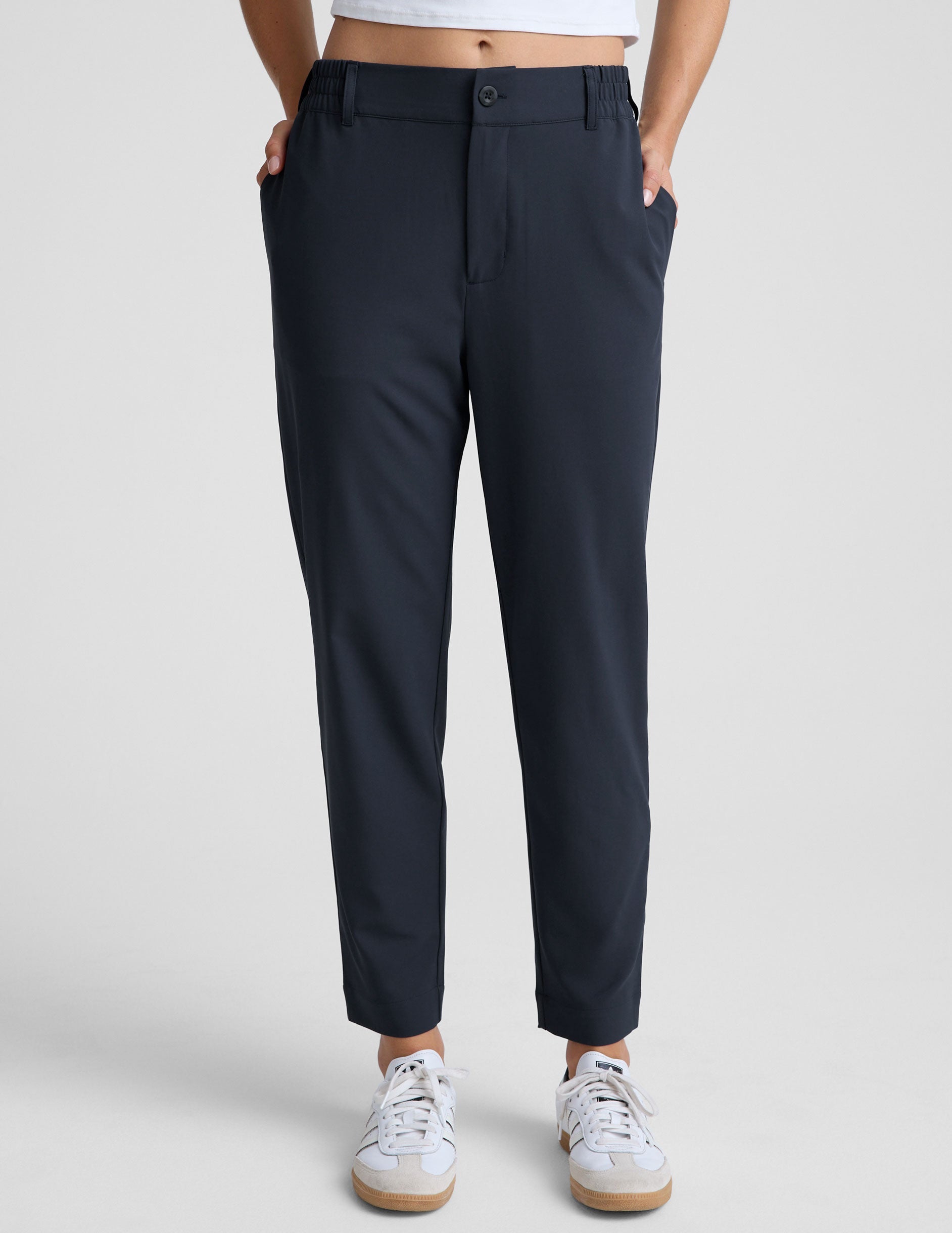 blue trouser style pant with a tapered ankle and pockets.