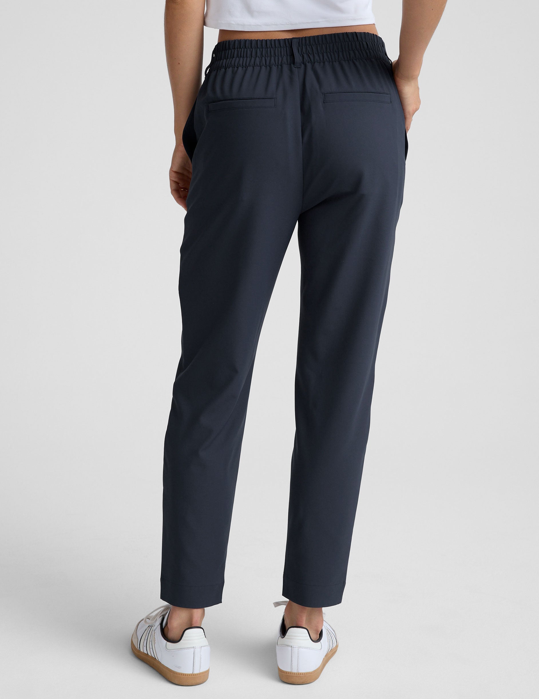 blue trouser style pant with a tapered ankle and pockets.