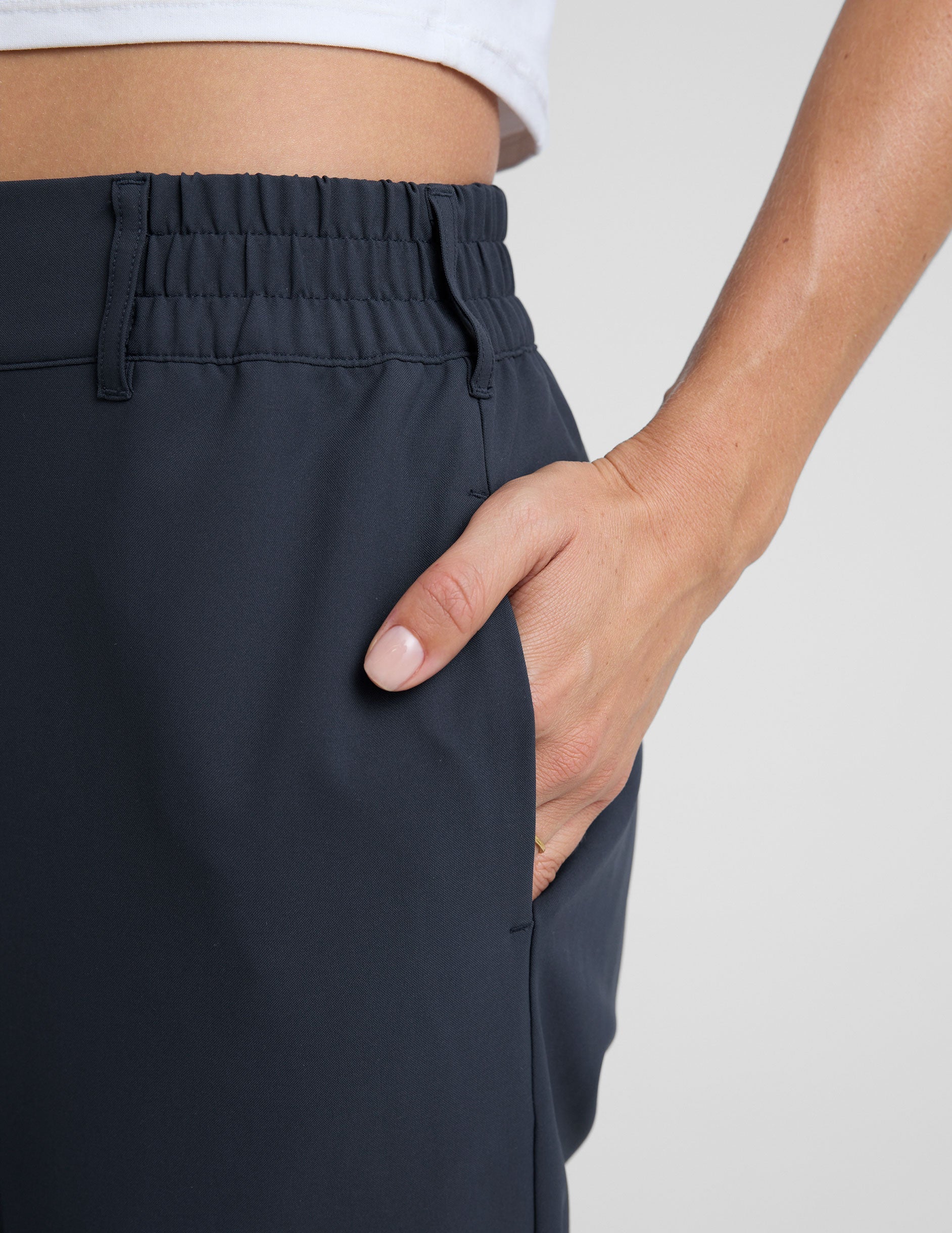 blue trouser style pant with a tapered ankle and pockets.