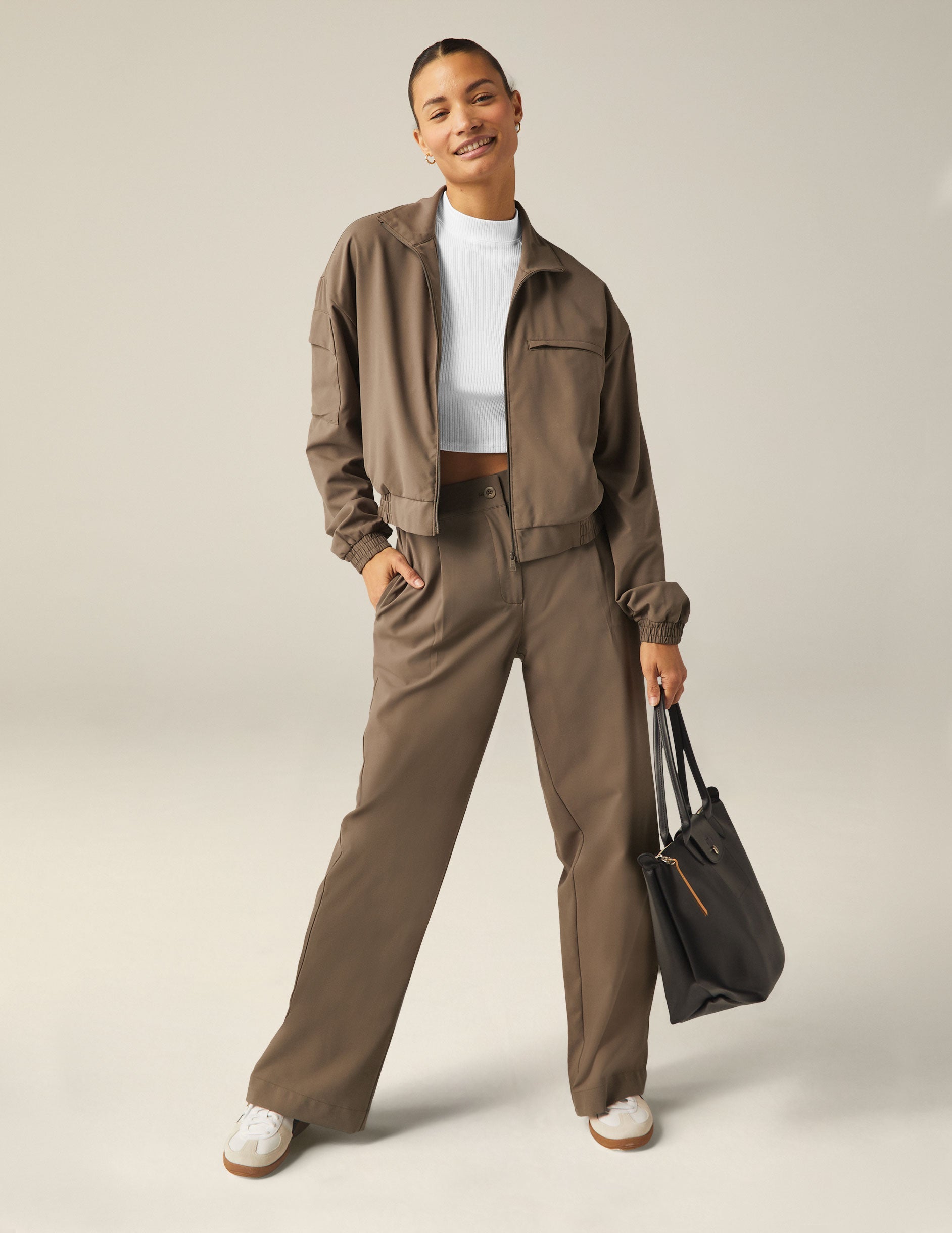 brown zip-up jetstretch woven jacket with a collar and pockets.