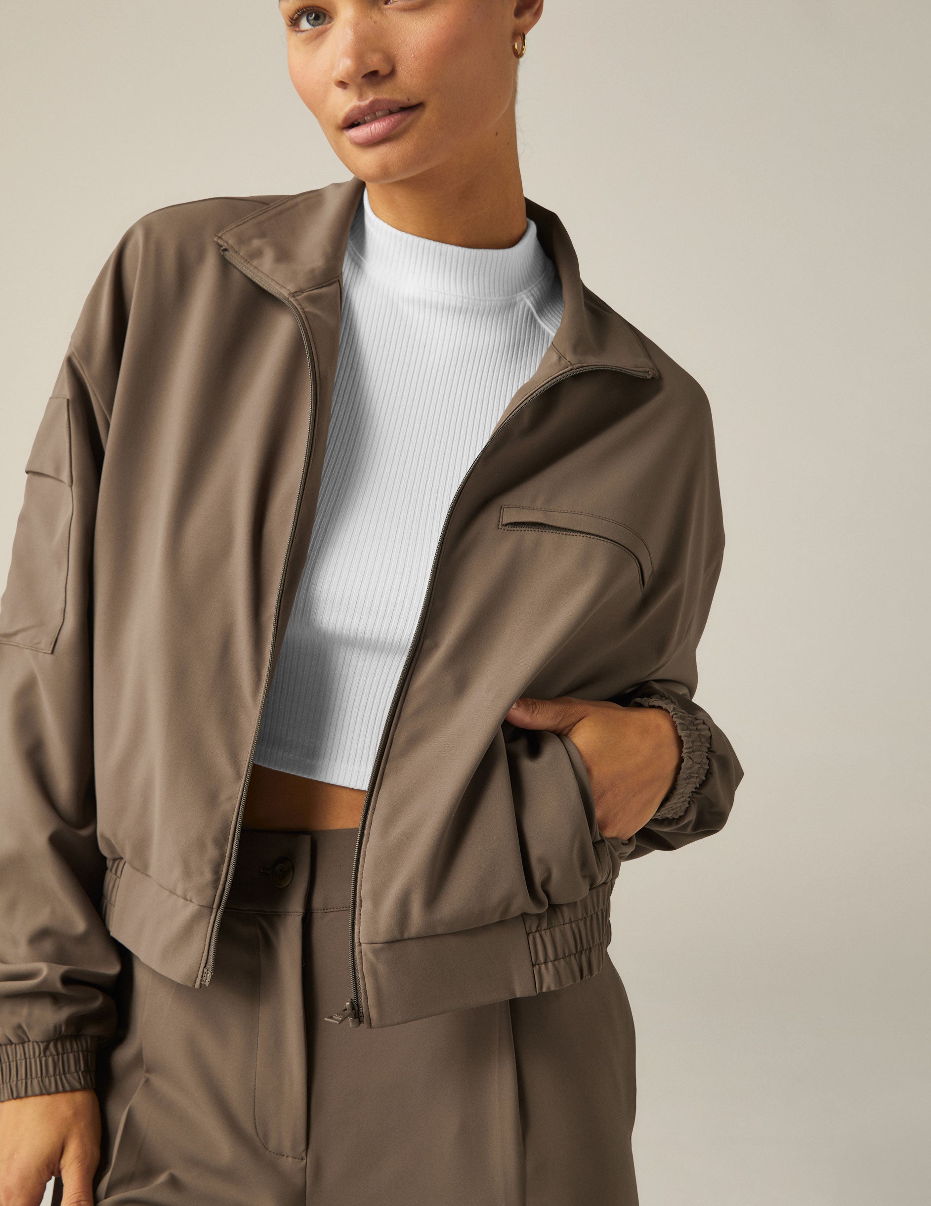 brown zip-up jetstretch woven jacket with a collar and pockets.