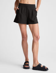 black high-waisted trouser shorts.