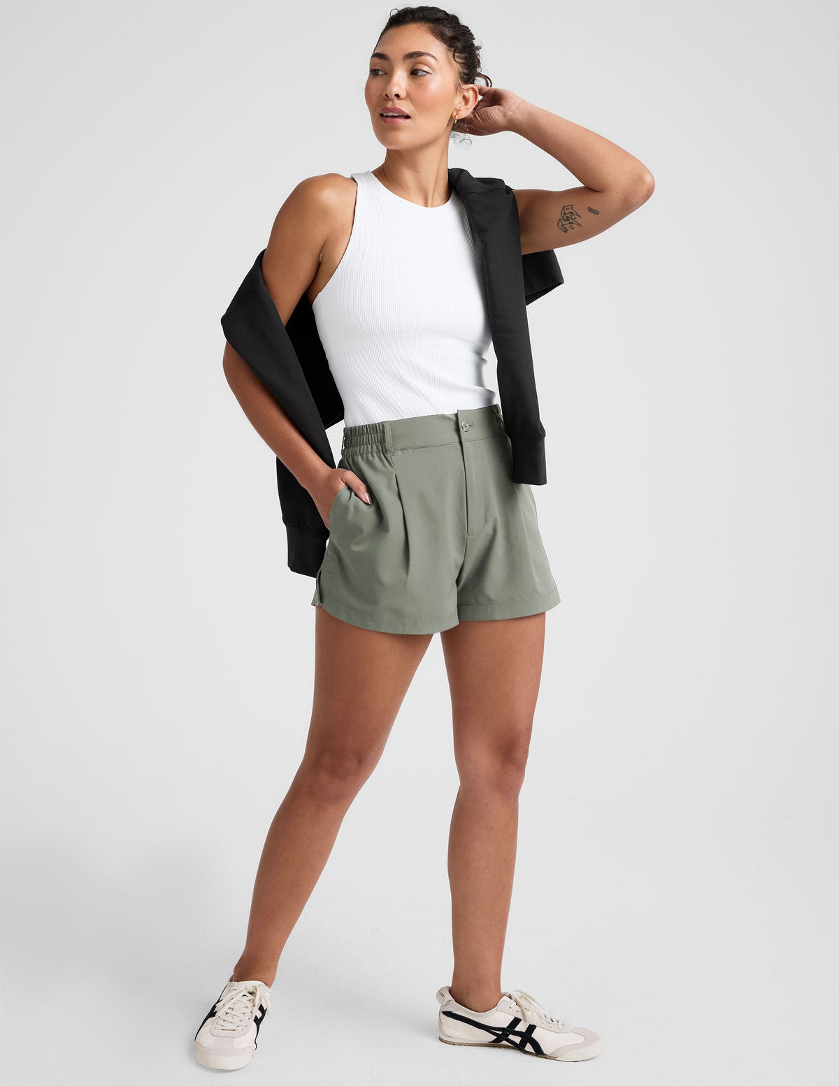 green shorts with an elastic waistband,  front zipper, button, and belt loops. 